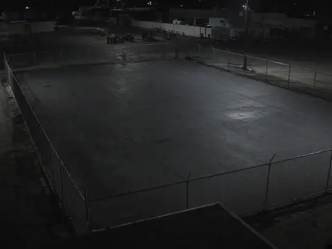 Business video monitoring view of an after-hours equipment yard for live security camera monitoring