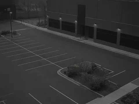 Live security camera monitoring of an after-hours commercial parking area for remote video monitoring