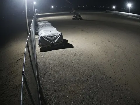 Live video monitoring of a commercial equipment yard perimeter at night for remote security camera monitoring