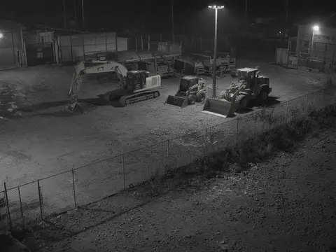 Remote security camera monitoring view of an after-hours equipment yard for live video monitoring