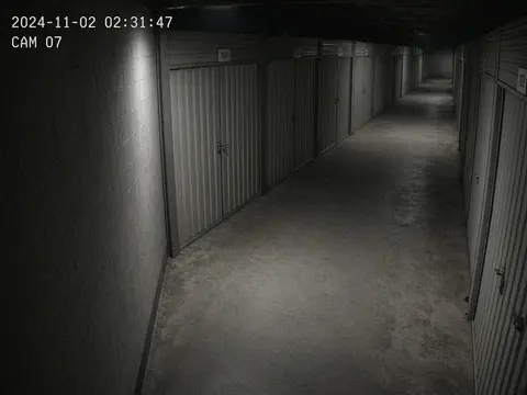 Live security camera monitoring of a quiet storage facility driveway for remote video monitoring